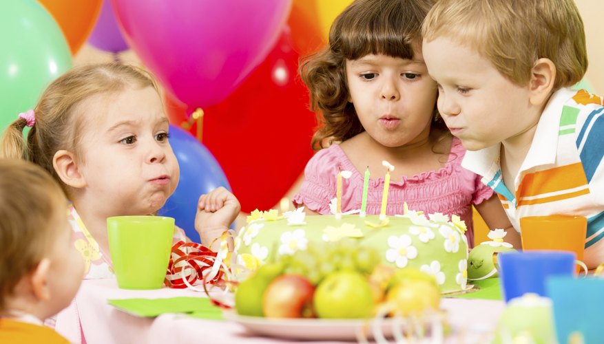 Children blowing out candles