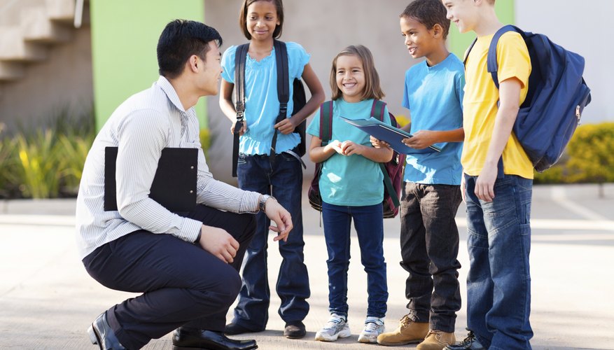Teacher speaking with elementary school students.