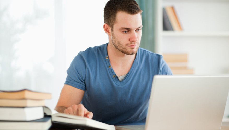 College student typing on a laptop