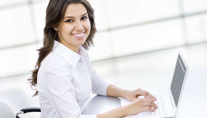 Young woman typing on laptop