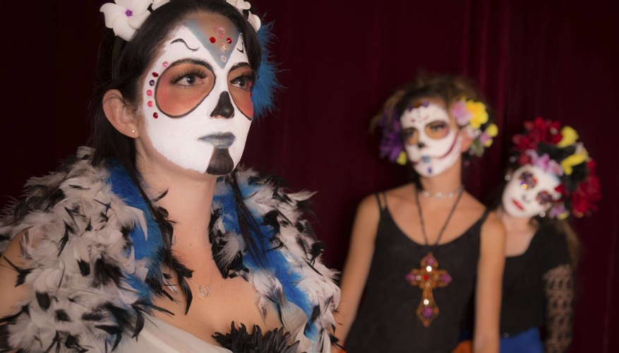 Three friends dressed for a Day of the Dead party.