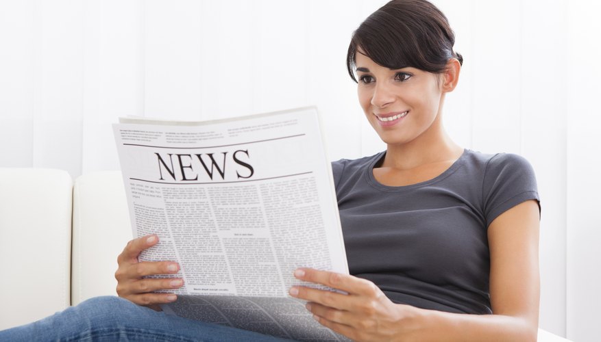 Woman reading a newspaper.