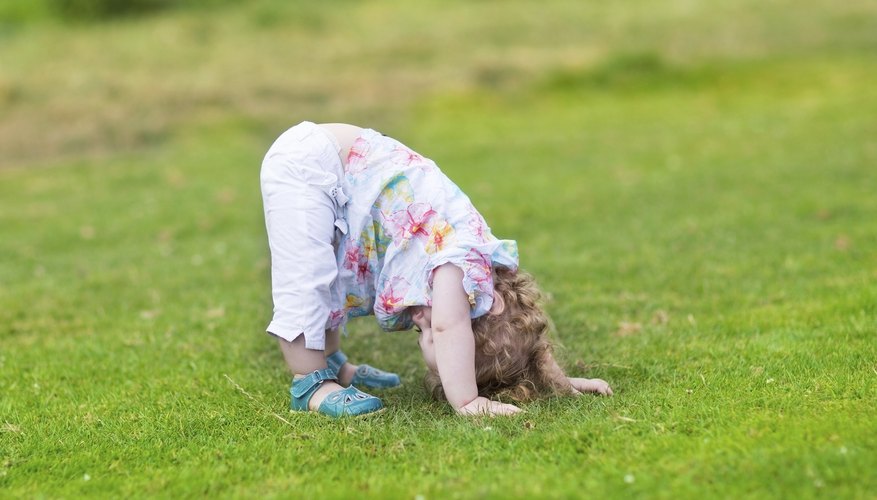Preschooler streching in grass