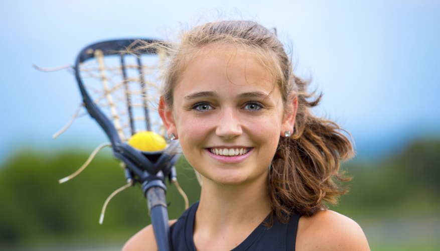 This smiling girl is a Lacrosse player, which was a game played by North America's indigenous tribes for many years.