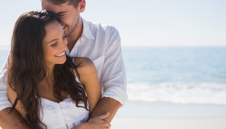 Happy young couple hugging on beach