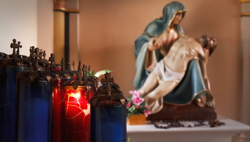 A church alter displays candles and statues during a service on Good Friday.