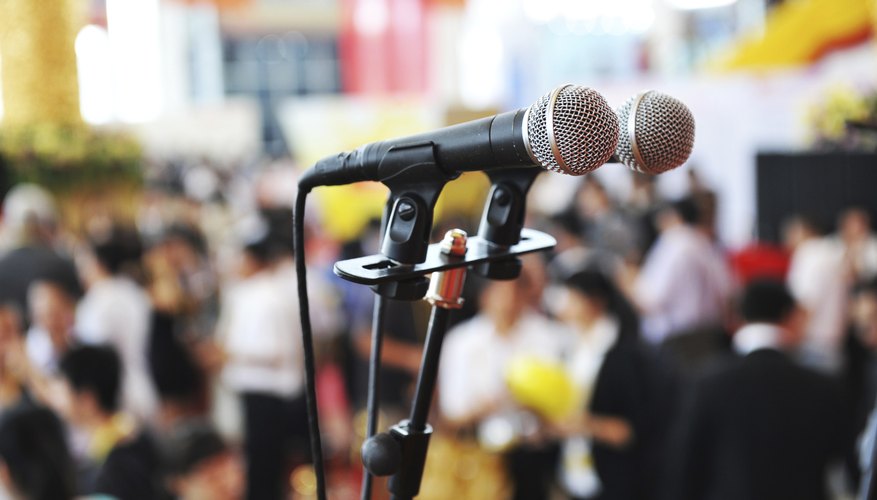 Close-up of microphone in large auditorium.