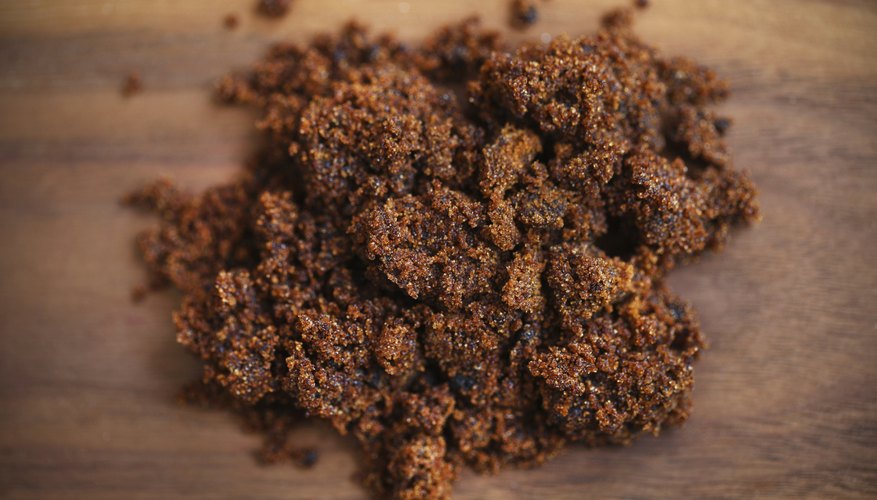 Brown sugar molasses on a wood table.