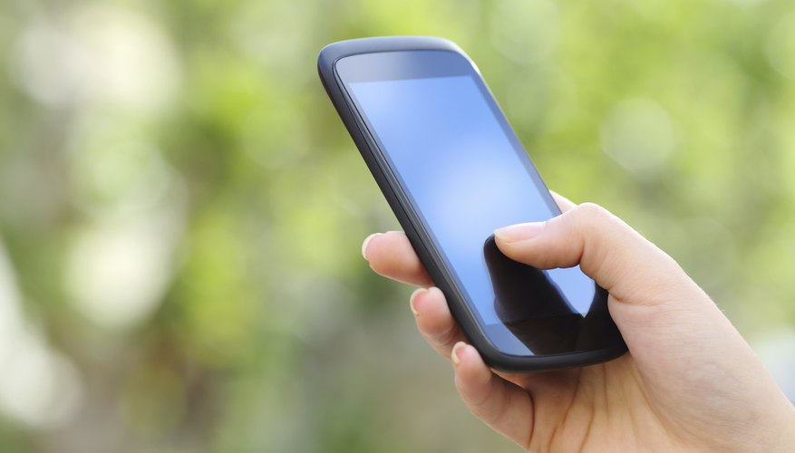 A woman's hand holding a smartphone