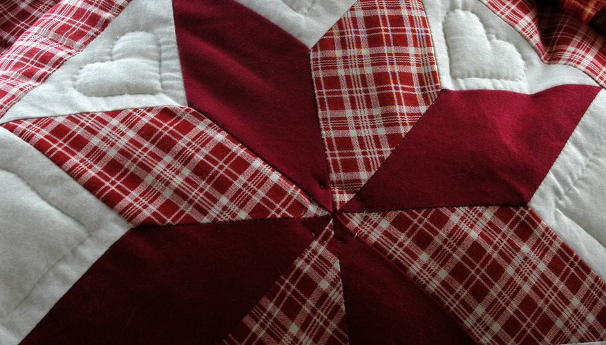 A close-up of an 8-point star stitched on an Amish quilt.