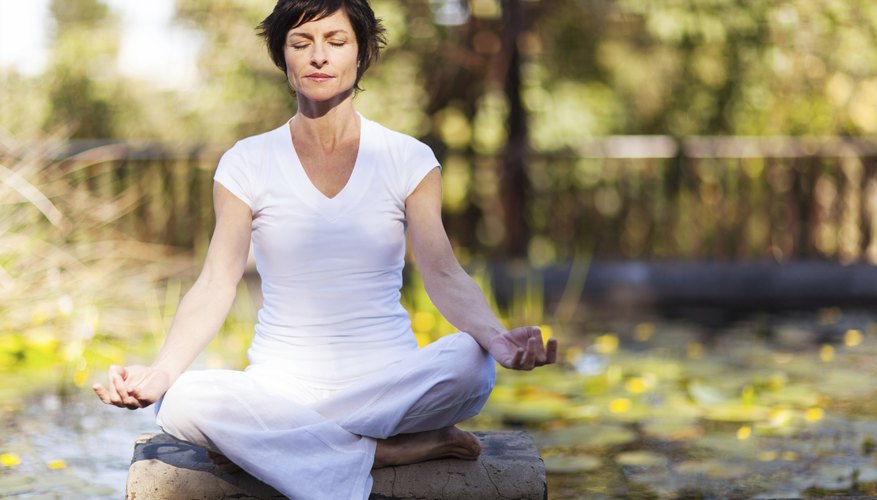 Woman meditating outdoors