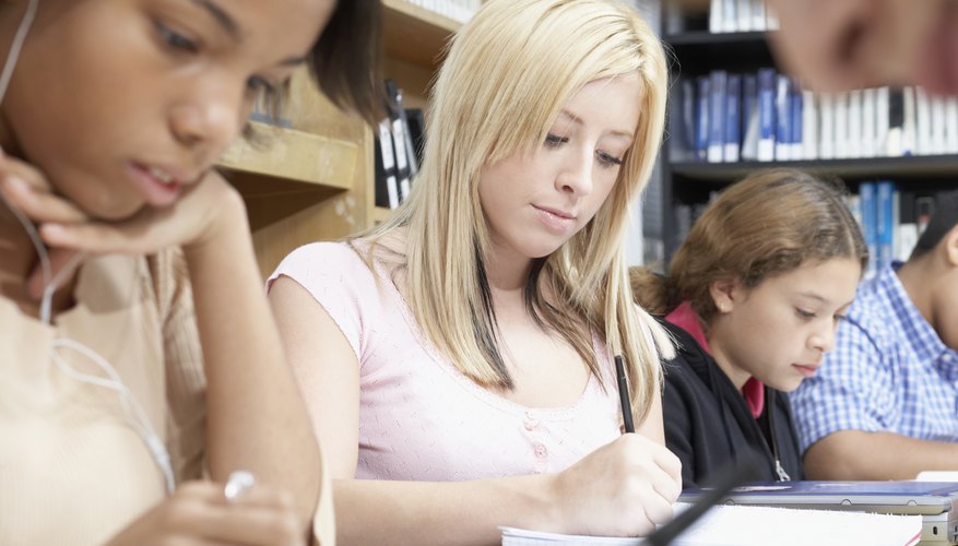 Kids are working on their notes in the classroom.