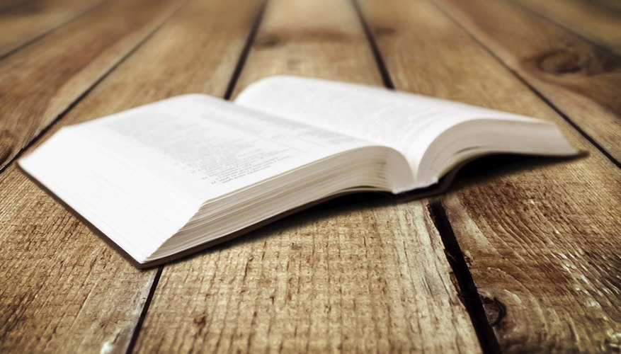 Open bible on wood table.