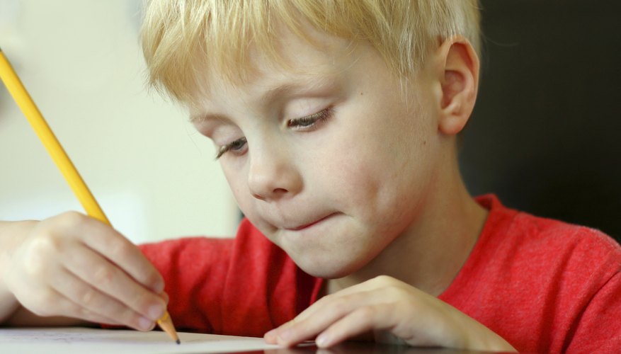 First grader using pencil to write