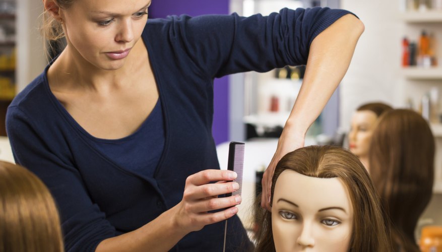 An apprentice practices on a mannequin.