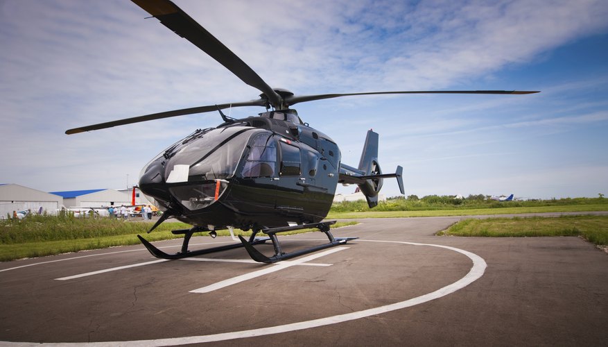 Black helicopter on landing pad