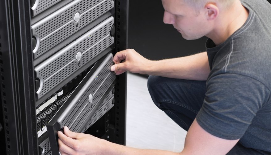 A technician works on a server mainframe.