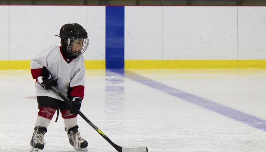 Young child playing hockey.