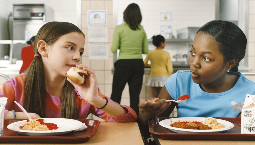Two young students eating lunch together.