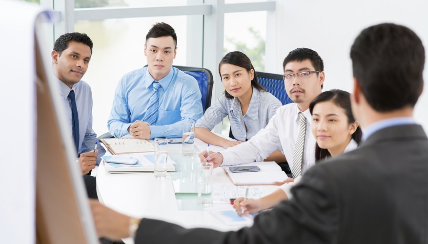 A young man gives a presentation to his fellow colleagues
