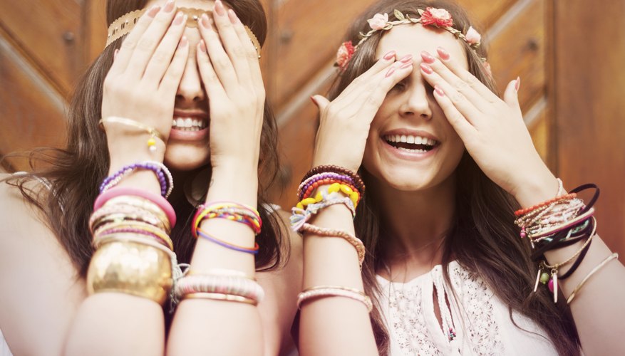 Two hippy girls wearing friendship bracelets.
