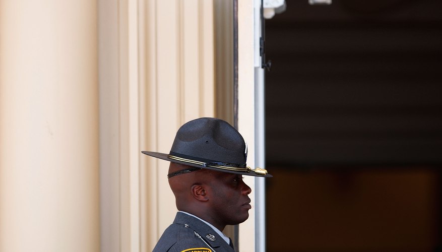 A North Carolina state trooper wears a campaign hat with his uniform.