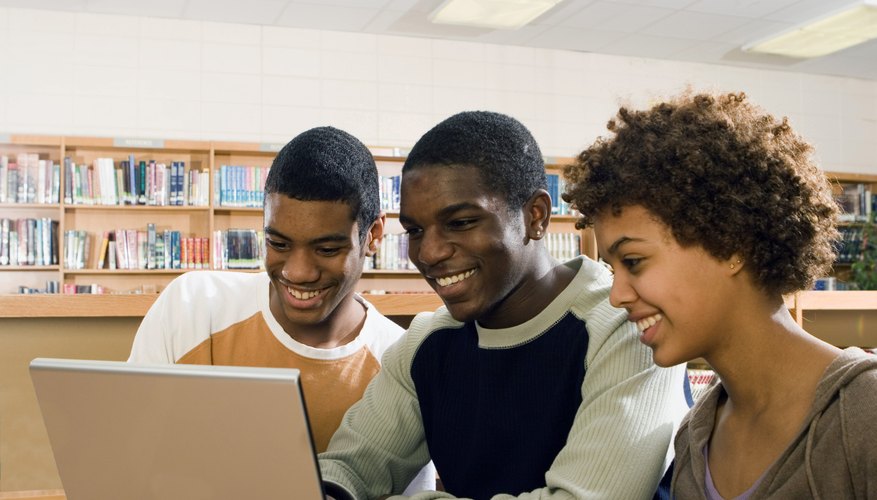 Students working on paper in library.