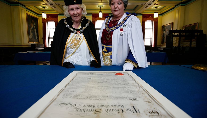 Women freemason leaders look over 1920 petition to the Grand Masonic Temple in London, England to allow women