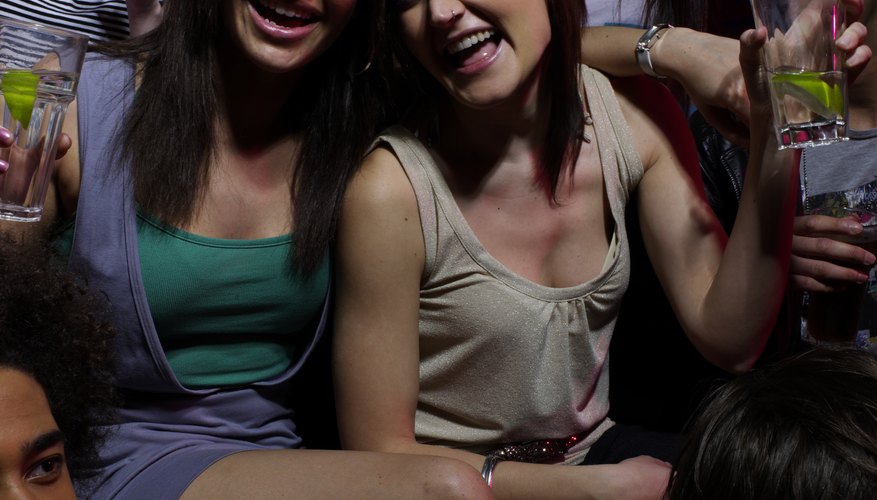 Approach your crush and her friend with a carefree, confident smile.