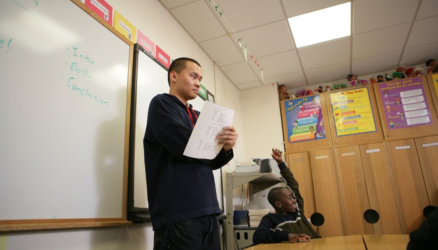 Teenage boy giving a speech in a classroom.