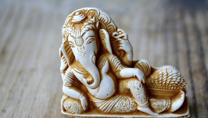 A statue of the Hindu idol, Ganesh, on a wooden table.