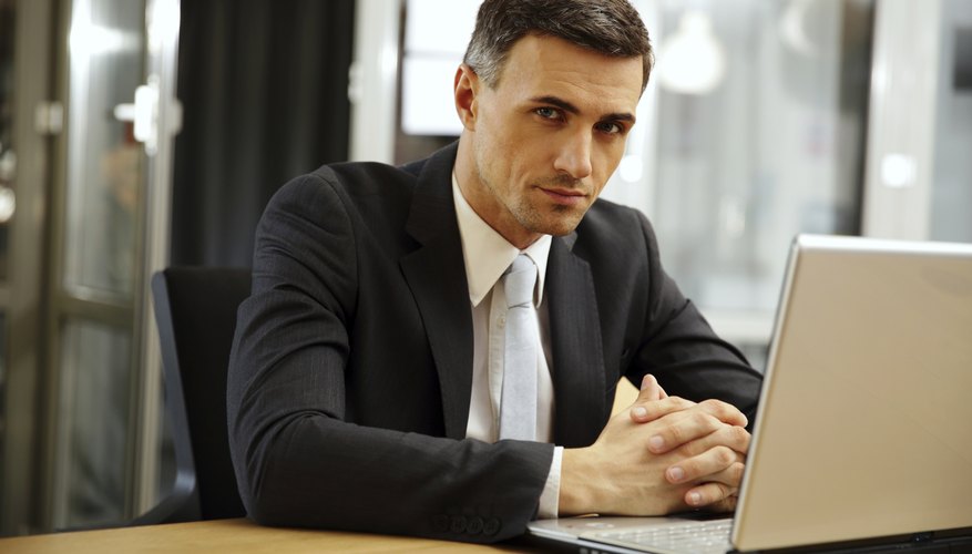 Lawyer sitting in front of laptop at desk