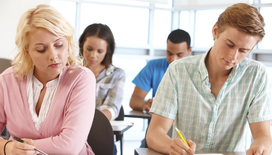 Image of college students working on an assignment.