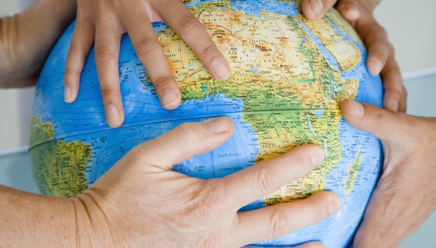 Hands on a globe.