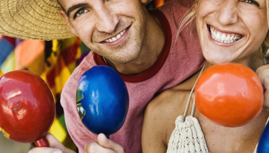 Tourists hold maracas and wear sombreros