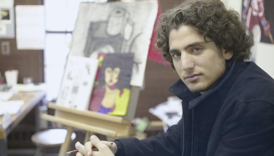 Man next to an easel full of art