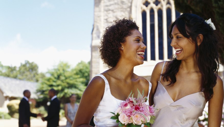 Bride and bridesmaid standing outside church