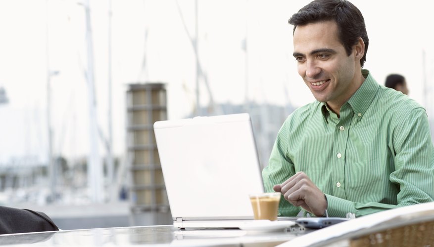 Man working on laptop in cafe.