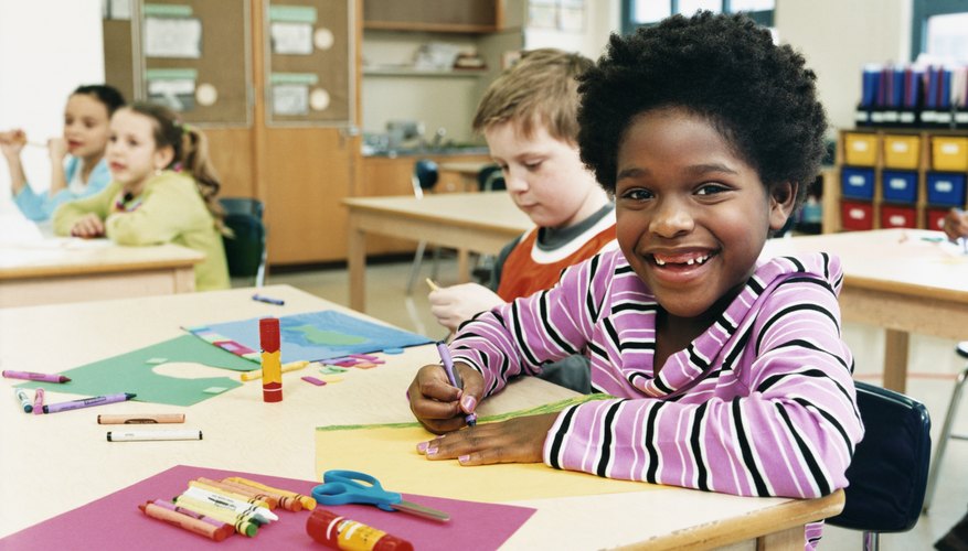 Smiling young children in classroom.
