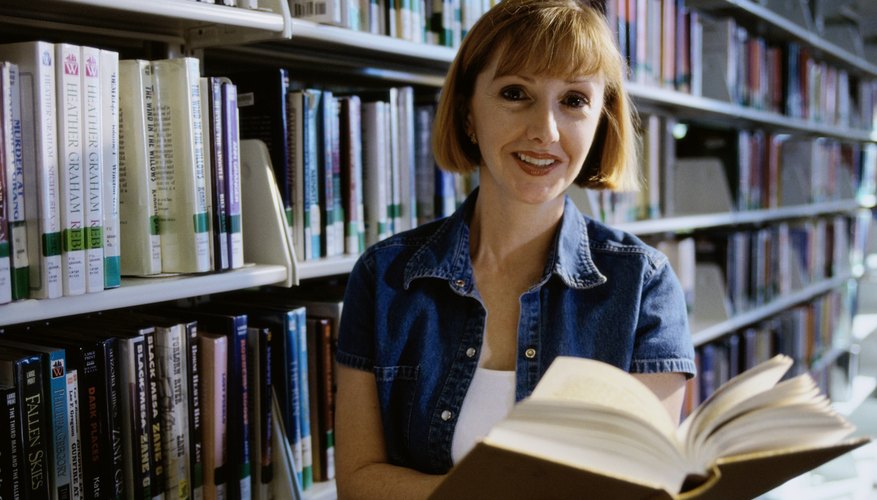 Woman holding a book in a library