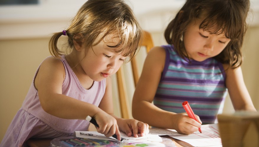 Preschoolers coloring in classroom.