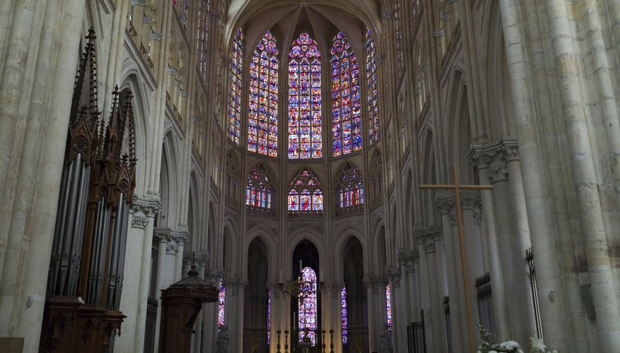 Though Gothic cathedrals allowed for larger windows, stained glass often made the interiors darker, as seen at Saint Gatien.