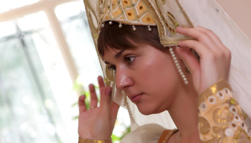 A woman adjusting a kokoshnik.