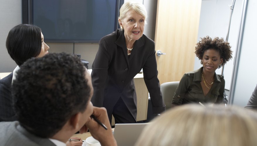 Moral leader talking to employees in office.