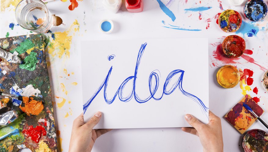 A person paints the word