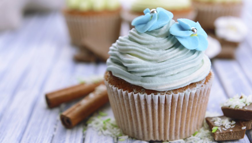 A cupcake with blue icing and garnish.