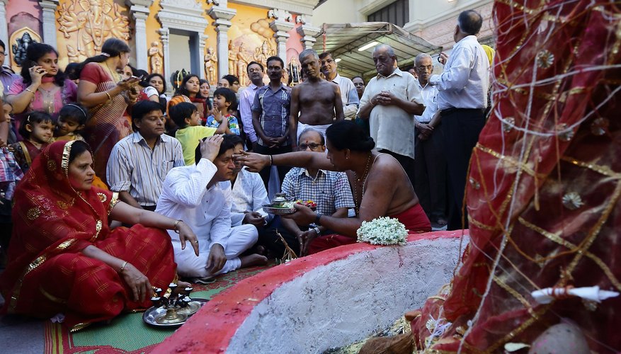 A priest performs a puja service in March 2013.