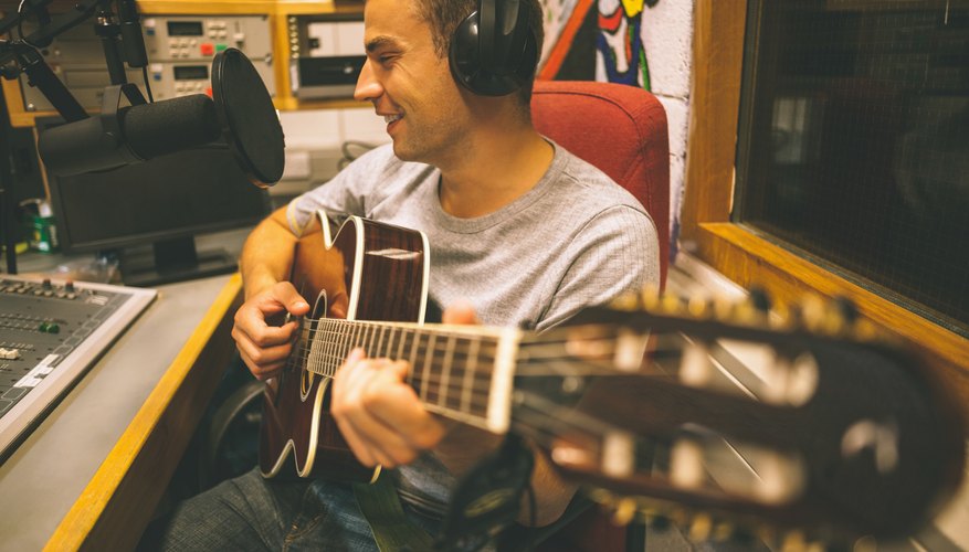 Singer recording and playing guitar
