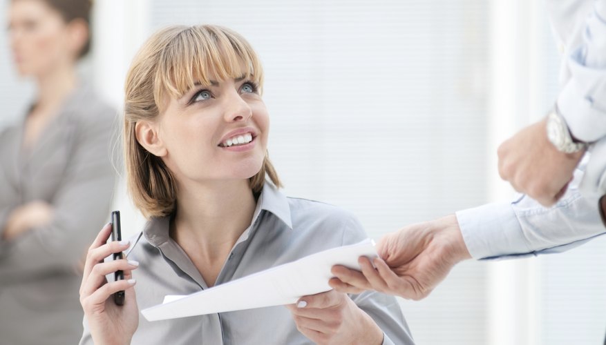 A woman is looking at a business letter.