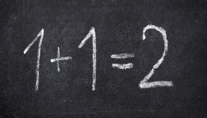 Close-up of addition problem written on chalkboard.
